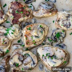 Cooked pork tenderloin in a creamy sauce with mushrooms, an elegant and easy dish.