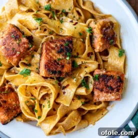 Plated Cajun Pasta With Salmon, a creamy and spicy pasta dish.