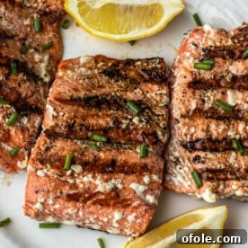Grilled Sockeye Salmon steaks on a white plate, showcasing beautiful grill marks.