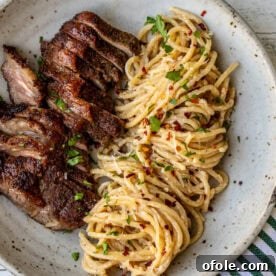 Steak and Pasta with homemade garlic cream sauce, a luxurious and comforting meal.