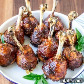 Plate of baked and glazed chicken lollipops, a fun and delicious presentation.