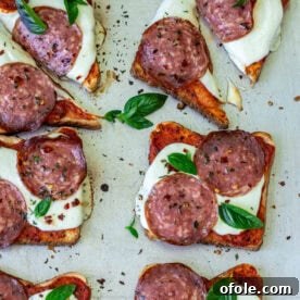 Pizza toast garnished with fresh basil, a quick and easy pizza alternative.