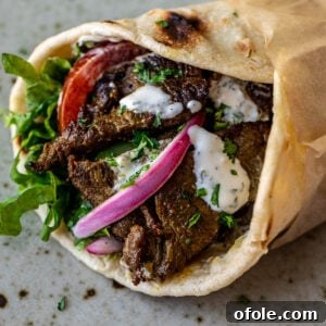 Close up image of beef shawarma wrap, tempting and flavorful.