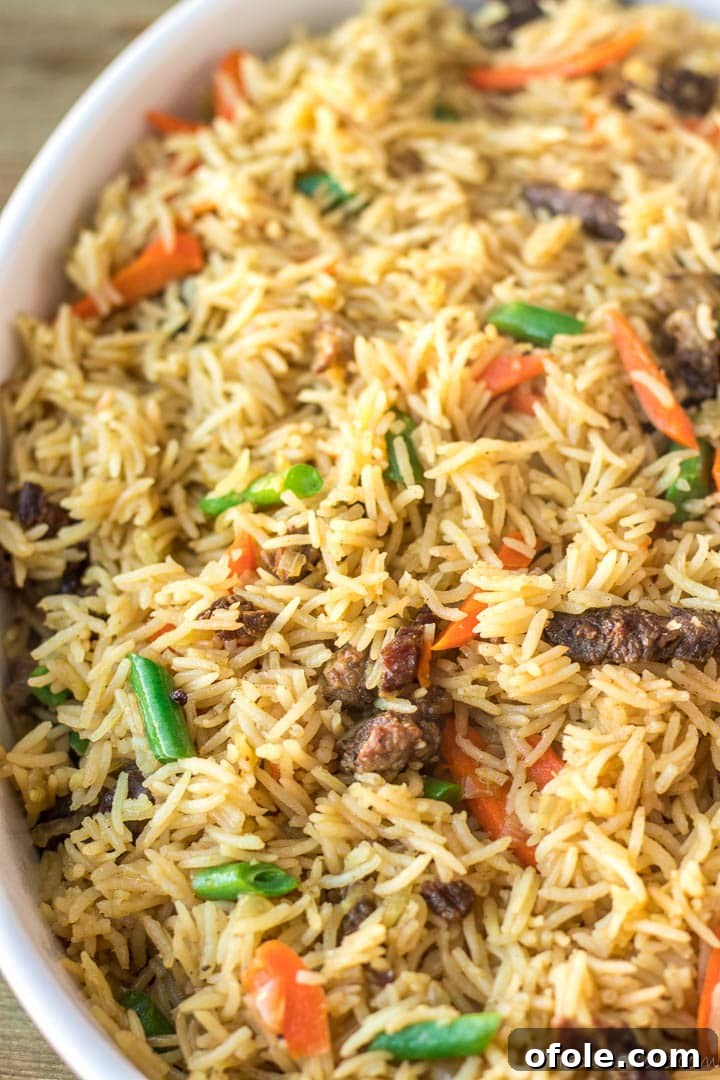 Close-up view of aromatic Beef Fried Rice, showing individual grains and tender beef pieces.