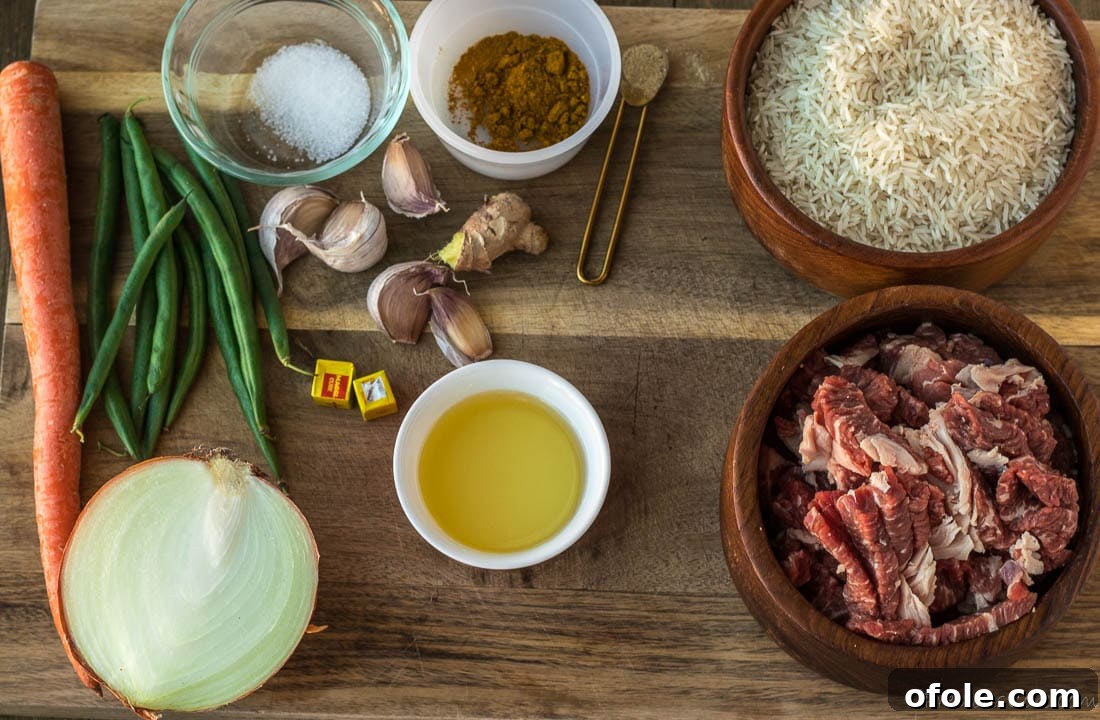 Close-up of raw ingredients for Beef Fried Rice: beef slices, ginger, garlic, spices, and oil on a wooden board.